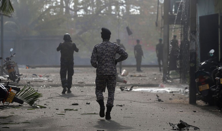 Sri Lankan security forces approaching a bombing site in Colombo, the country's capital