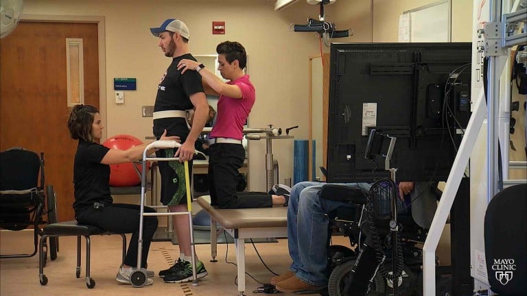 Paralysed man stands in rehab center