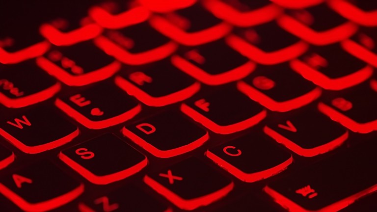 A black keyboard with a red backlight.