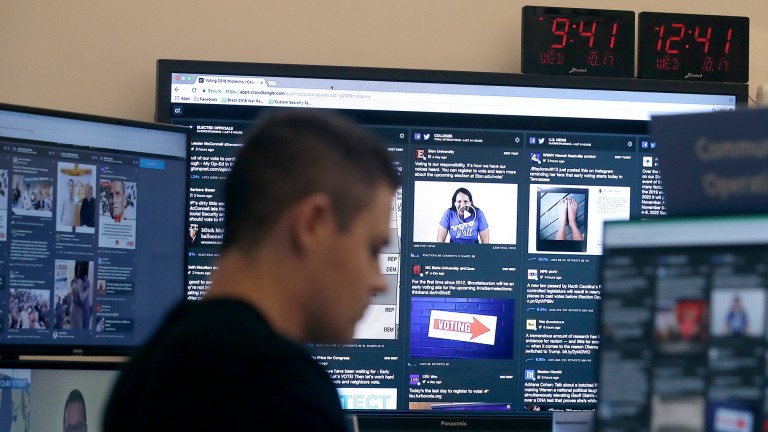 A man sits in front of monitors in Facebook's election "war room"