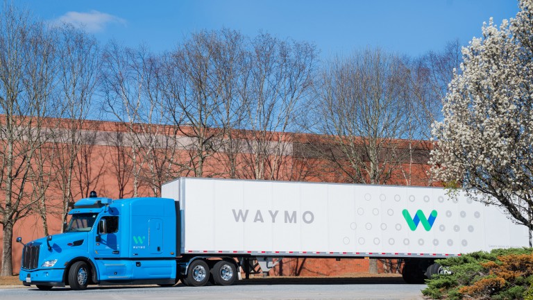 A photo of a semi truck with the word "WAYMO" written on it