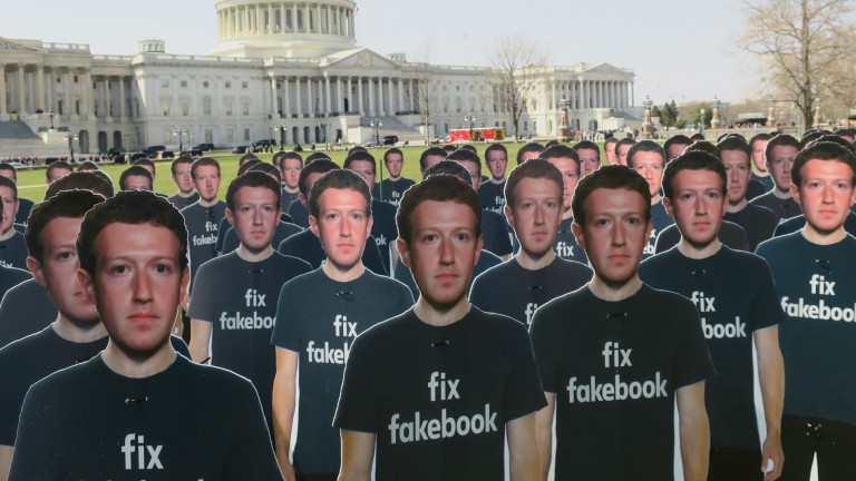 cut outs of zuckerberg in front of congress